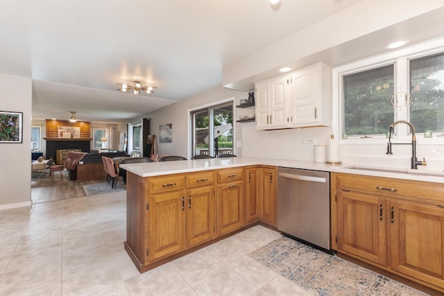 16064 Raintree Rd, Bloomington, IL 61705 - kitchen featuring stainless steel dishwasher, light countertops, a peninsula, and light tile patterned floors