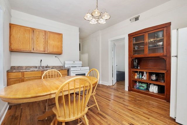 1630 S Fairfield Ave, Chicago, IL 60608 - dining space featuring light wood-type flooring and a chandelier