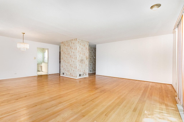 712 Central Park Ave, Flossmoor, IL 60422 - empty room with a chandelier and light wood-style floors