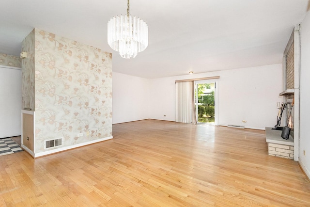 712 Central Park Ave, Flossmoor, IL 60422 - unfurnished living room featuring a chandelier and light wood-style floors
