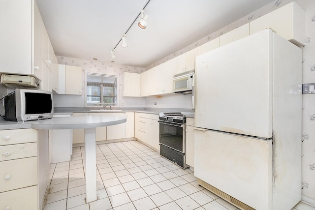 712 Central Park Ave, Flossmoor, IL 60422 - kitchen featuring white appliances, light countertops, track lighting, light tile patterned flooring, and white cabinets