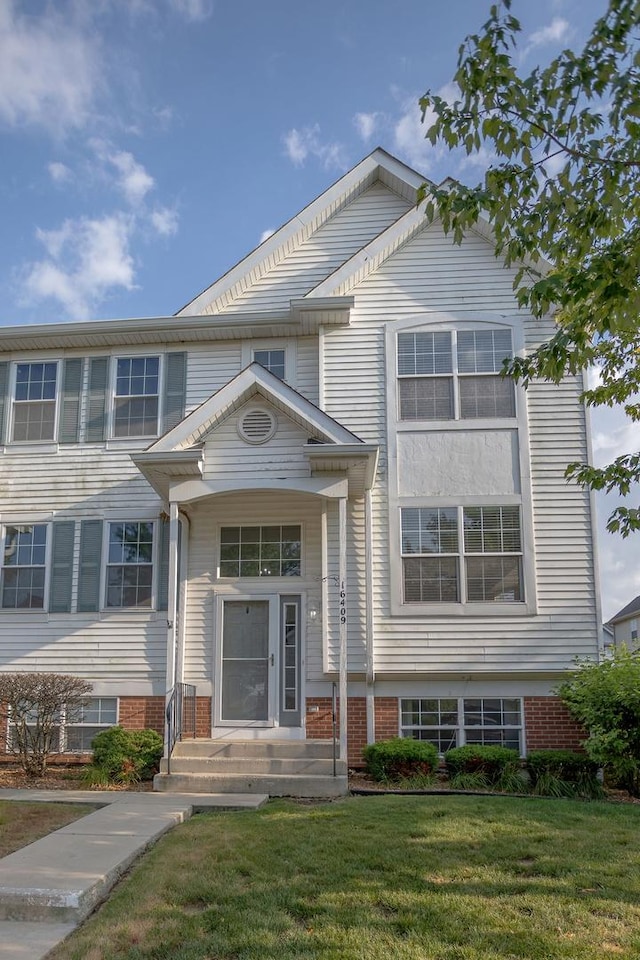 16409 Teton Dr Unit D, Lockport, IL 60441 - view of front of home with a front lawn and brick siding