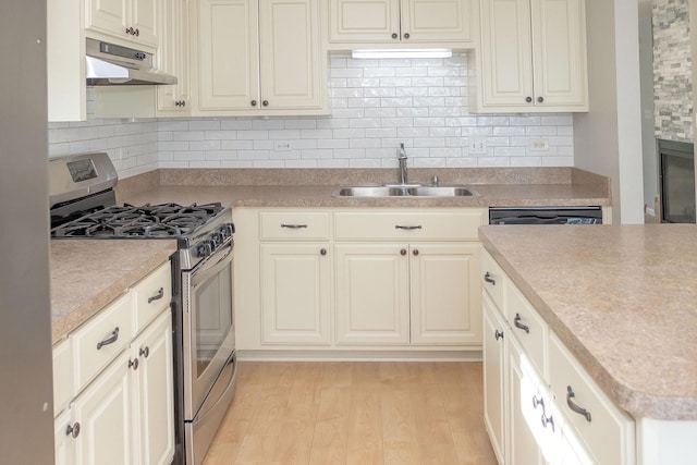 16409 Teton Dr Unit D, Lockport, IL 60441 - kitchen featuring stainless steel gas range oven, under cabinet range hood, backsplash, and light wood-style flooring