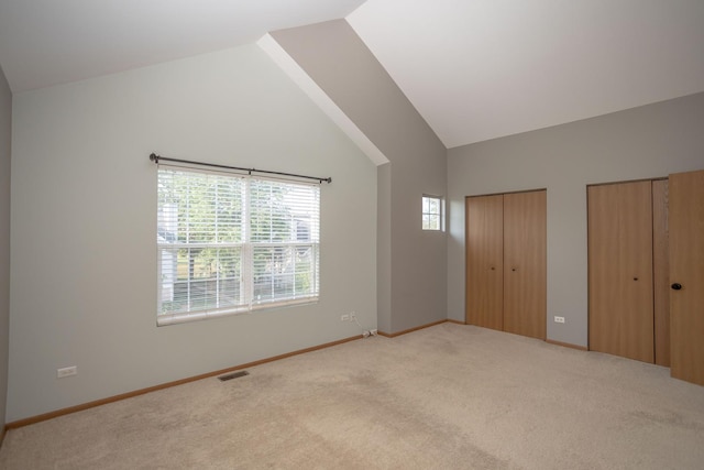 16409 Teton Dr Unit D, Lockport, IL 60441 - unfurnished bedroom featuring carpet floors, multiple closets, and high vaulted ceiling