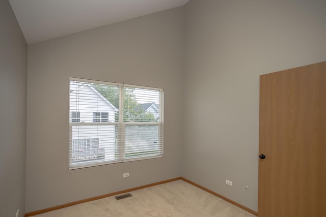 16409 Teton Dr Unit D, Lockport, IL 60441 - spare room with light carpet and high vaulted ceiling