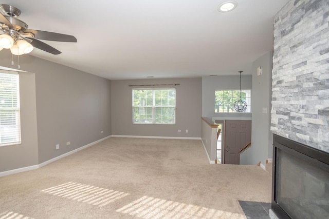 16409 Teton Dr Unit D, Lockport, IL 60441 - unfurnished living room with ceiling fan, light colored carpet, and a stone fireplace
