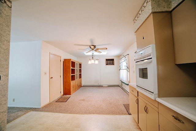 100 W Herron Ct, Watseka, IL 60970 - kitchen with white oven, light colored carpet, light countertops, and a ceiling fan