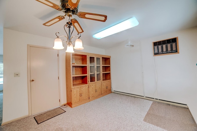 100 W Herron Ct, Watseka, IL 60970 - empty room with baseboard heating, carpet, and a ceiling fan