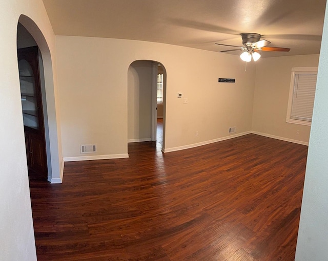 10N850 Rippburger Rd, Elgin, IL 60124 - spare room featuring ceiling fan, dark wood-style flooring, and arched walkways