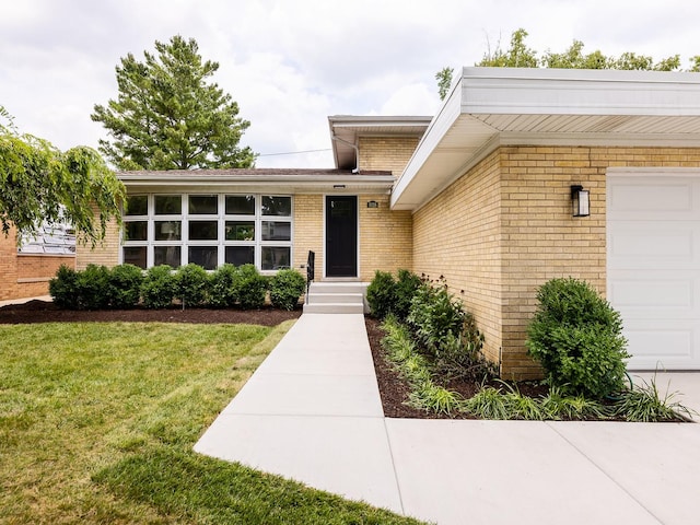 5028 Coyle Ave, Skokie, IL 60077 - doorway to property featuring a garage, brick siding, and a lawn