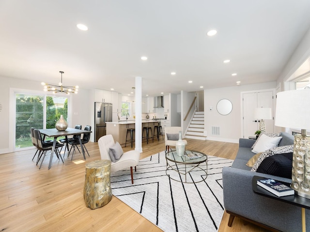 5028 Coyle Ave, Skokie, IL 60077 - living area featuring light wood-style floors, stairway, a chandelier, and recessed lighting
