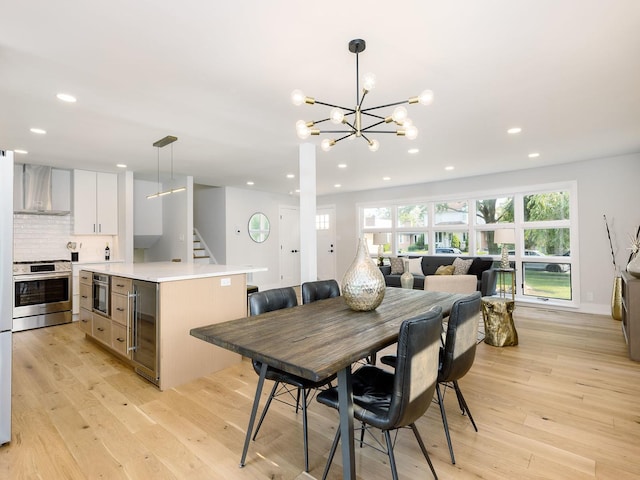 5028 Coyle Ave, Skokie, IL 60077 - dining area featuring beverage cooler, light wood-style flooring, recessed lighting, a chandelier, and stairway