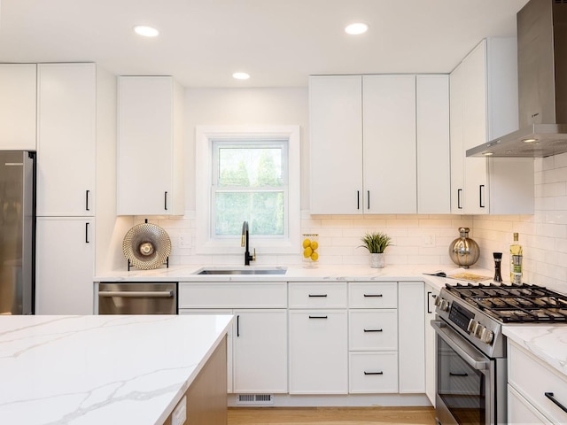 5028 Coyle Ave, Skokie, IL 60077 - kitchen featuring wall chimney exhaust hood, appliances with stainless steel finishes, light stone countertops, decorative backsplash, and white cabinetry