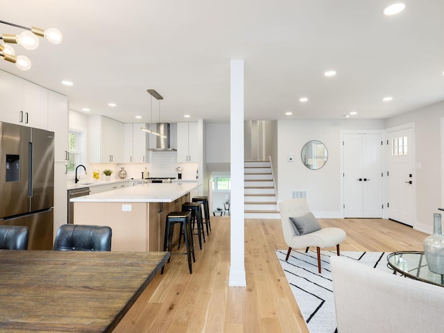5028 Coyle Ave, Skokie, IL 60077 - living area with stairs, plenty of natural light, light wood finished floors, and recessed lighting