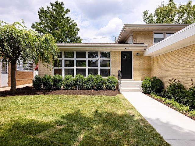 5028 Coyle Ave, Skokie, IL 60077 - doorway to property featuring brick siding and a yard