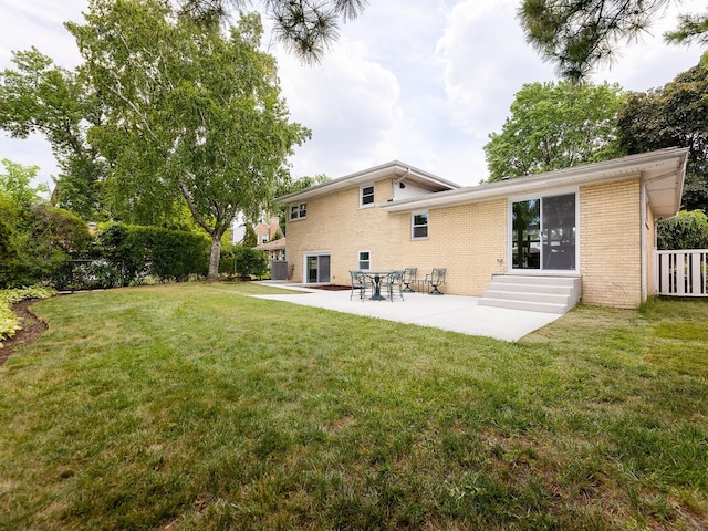 5028 Coyle Ave, Skokie, IL 60077 - rear view of house with brick siding, entry steps, a patio, and a yard