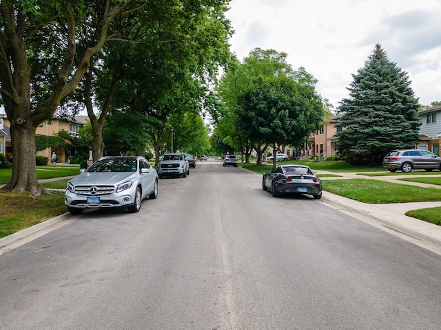 5028 Coyle Ave, Skokie, IL 60077 - view of asphalt road featuring sidewalks, curbs, and a residential view