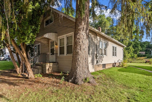 2911 Preston St, Rockford, IL 61102 - view of side of home with a lawn and a chimney