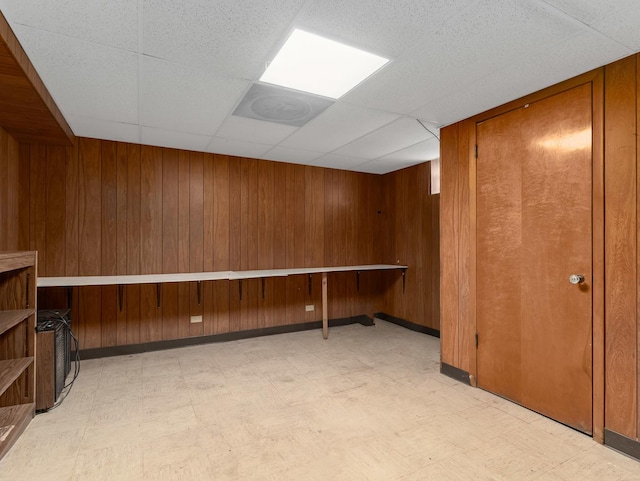 2443 S 4th Ave, North Riverside, IL 60546 - spare room with light flooring, wood walls, and a drop ceiling