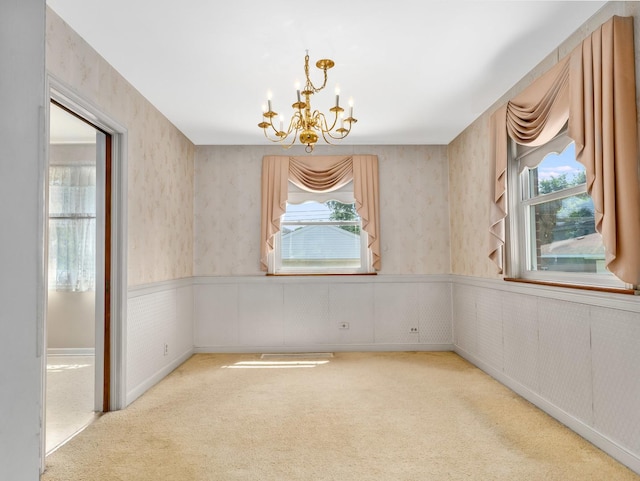 2443 S 4th Ave, North Riverside, IL 60546 - carpeted empty room with a wainscoted wall, a chandelier, wallpapered walls, and plenty of natural light