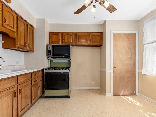 2443 S 4th Ave, North Riverside, IL 60546 - kitchen featuring black microwave, gas stove, brown cabinets, ceiling fan, and backsplash