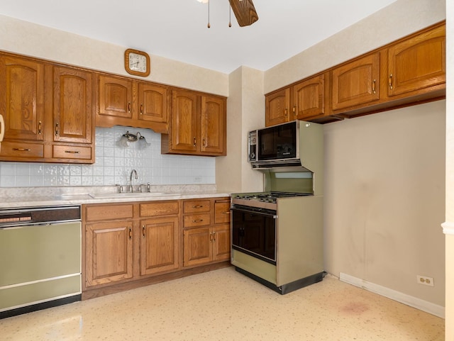 2443 S 4th Ave, North Riverside, IL 60546 - kitchen with white dishwasher, brown cabinets, light countertops, and decorative backsplash