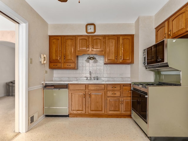 2443 S 4th Ave, North Riverside, IL 60546 - kitchen with dishwasher, range with gas stovetop, brown cabinetry, decorative backsplash, and light countertops
