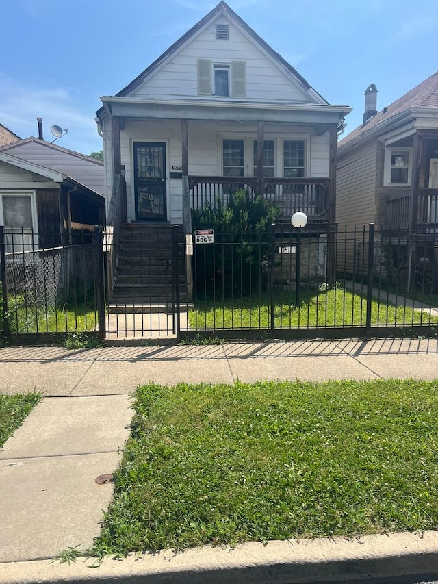 7411 S Morgan St, Chicago, IL 60621 - view of front facade with a porch, a fenced front yard, and a gate