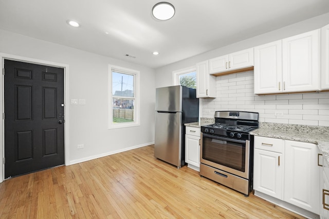 712 W 48th Pl, Chicago, IL 60609 - kitchen with stainless steel appliances, white cabinets, backsplash, light wood-style floors, and recessed lighting