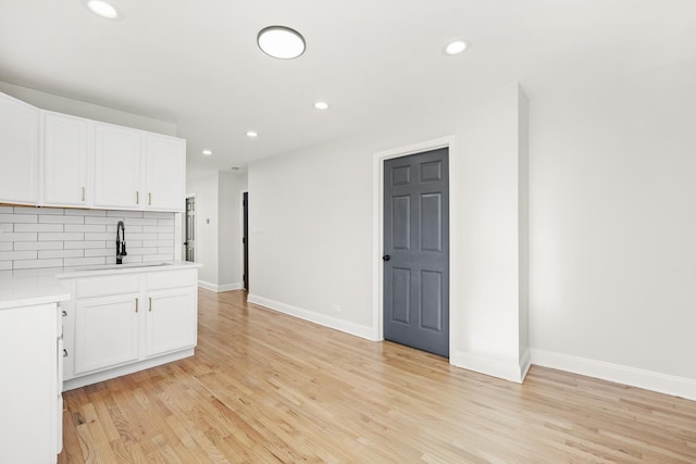 712 W 48th Pl, Chicago, IL 60609 - kitchen with light countertops, tasteful backsplash, recessed lighting, light wood-style flooring, and white cabinetry
