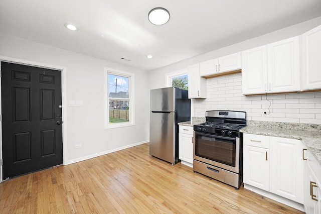 712 W 48th Pl, Chicago, IL 60609 - kitchen with stainless steel appliances, white cabinets, tasteful backsplash, light wood finished floors, and recessed lighting