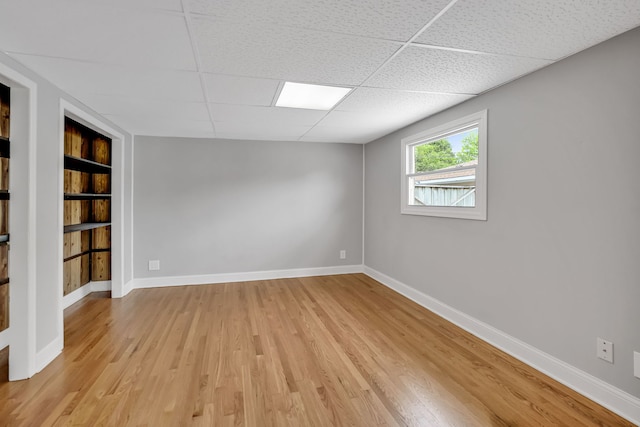 12247 S Avers Ave, Alsip, IL 60803 - spare room featuring built in features, a drop ceiling, and light wood-style floors