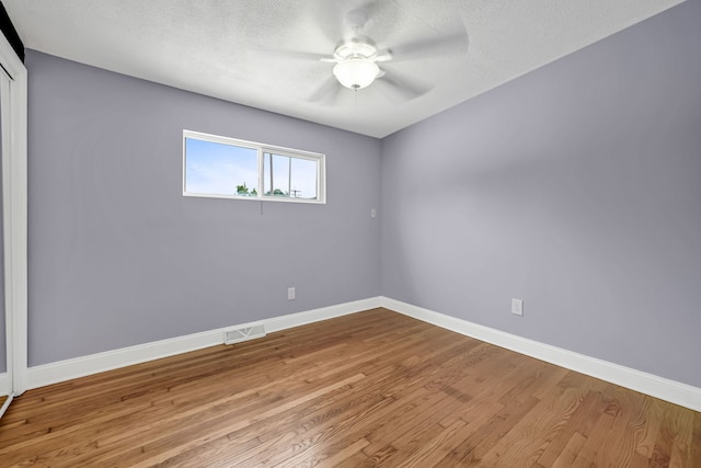 12247 S Avers Ave, Alsip, IL 60803 - spare room with wood finished floors, ceiling fan, and a textured ceiling