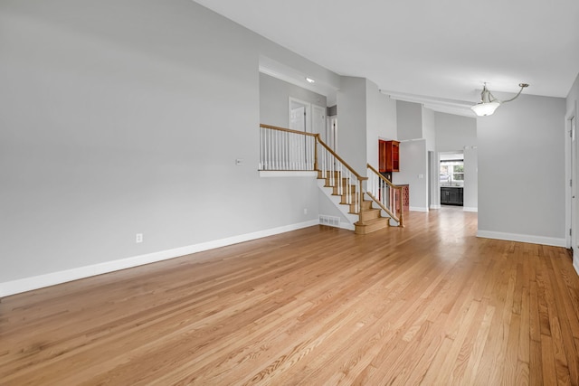 12247 S Avers Ave, Alsip, IL 60803 - unfurnished living room featuring stairs, light wood finished floors, and high vaulted ceiling