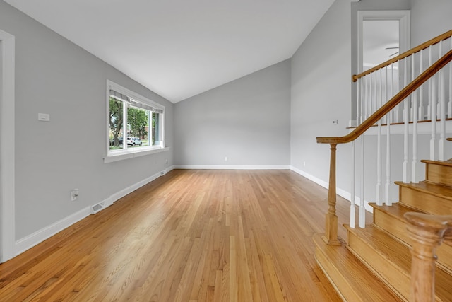12247 S Avers Ave, Alsip, IL 60803 - unfurnished living room featuring lofted ceiling, light wood-style floors, and stairway