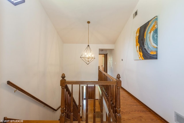134 Country Club Dr, Bloomingdale, IL 60108 - stairway with a chandelier, wood finished floors, and lofted ceiling