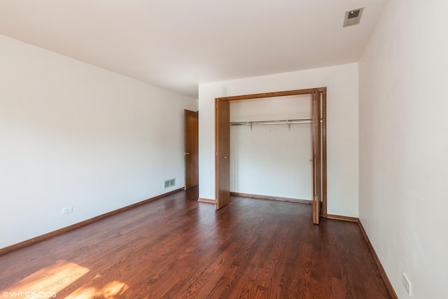 134 Country Club Dr, Bloomingdale, IL 60108 - unfurnished bedroom featuring dark wood finished floors and a closet