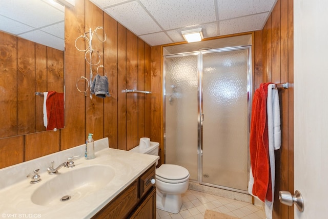 134 Country Club Dr, Bloomingdale, IL 60108 - bathroom featuring a drop ceiling, vanity, a shower stall, wood walls, and tile patterned flooring