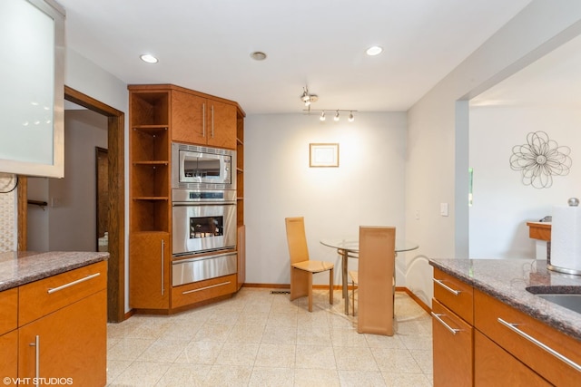 134 Country Club Dr, Bloomingdale, IL 60108 - kitchen featuring appliances with stainless steel finishes, a warming drawer, open shelves, brown cabinetry, and dark stone countertops