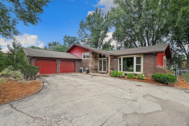 13420 Florence Rd, Mokena, IL 60448 - tri-level home featuring brick siding, driveway, an attached garage, and a shingled roof