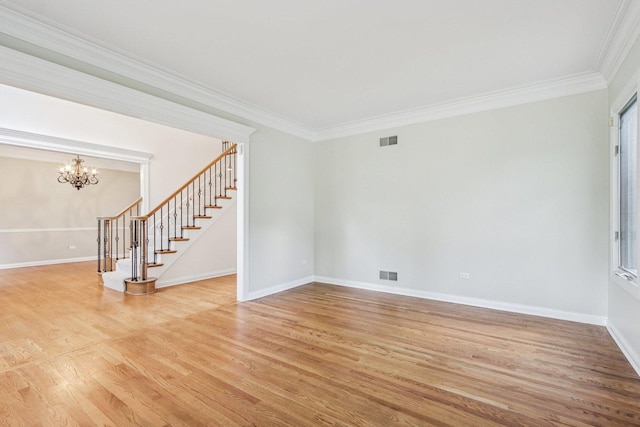 641 Mason Ln, Lake In The Hills, IL 60156 - empty room with stairs, ornamental molding, light wood-type flooring, and a chandelier