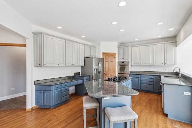 641 Mason Ln, Lake In The Hills, IL 60156 - kitchen with appliances with stainless steel finishes, a center island, a kitchen bar, recessed lighting, and dark stone countertops