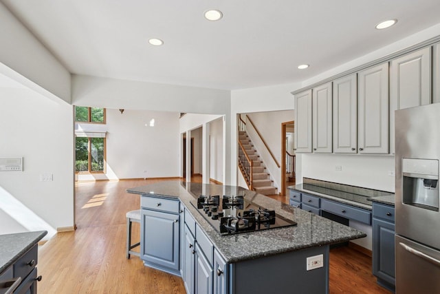 641 Mason Ln, Lake In The Hills, IL 60156 - kitchen featuring stainless steel fridge, black gas stovetop, a center island, light wood-style floors, and recessed lighting