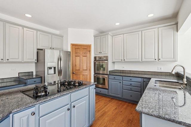 641 Mason Ln, Lake In The Hills, IL 60156 - kitchen featuring appliances with stainless steel finishes, light wood-type flooring, dark stone countertops, recessed lighting, and white cabinets