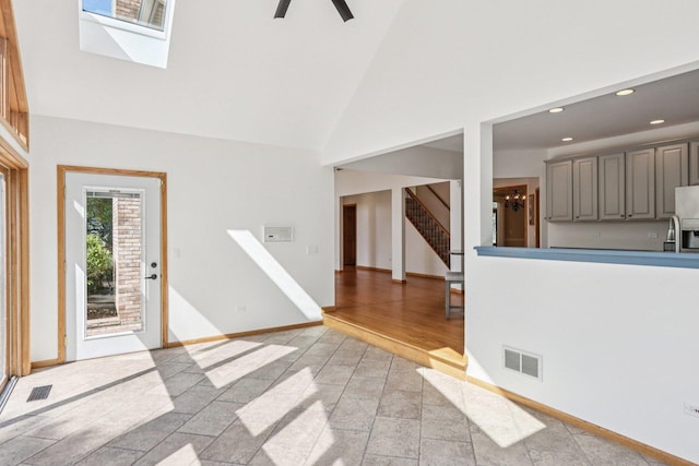 641 Mason Ln, Lake In The Hills, IL 60156 - foyer entrance with high vaulted ceiling, stairway, recessed lighting, stone tile floors, and a skylight