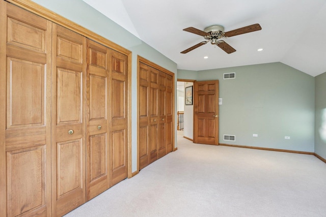 641 Mason Ln, Lake In The Hills, IL 60156 - unfurnished bedroom with multiple closets, light colored carpet, vaulted ceiling, ceiling fan, and recessed lighting
