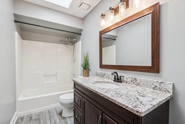 641 Mason Ln, Lake In The Hills, IL 60156 - full bathroom featuring vanity, wood finished floors, washtub / shower combination, and a skylight