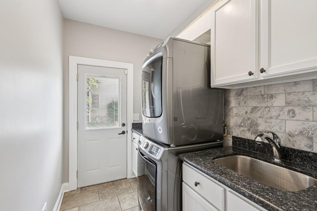 641 Mason Ln, Lake In The Hills, IL 60156 - laundry room with stacked washing machine and dryer, cabinet space, and stone tile floors