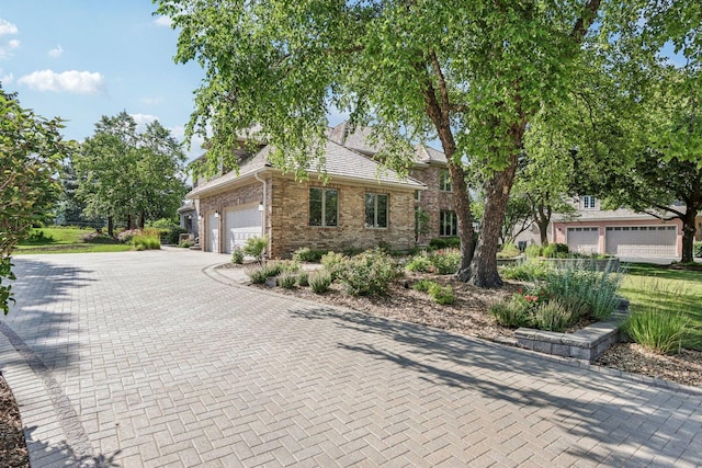 641 Mason Ln, Lake In The Hills, IL 60156 - view of front of house with brick siding, an attached garage, and decorative driveway