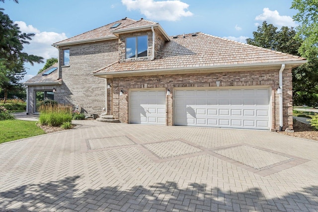 641 Mason Ln, Lake In The Hills, IL 60156 - view of property exterior with decorative driveway, brick siding, and a garage